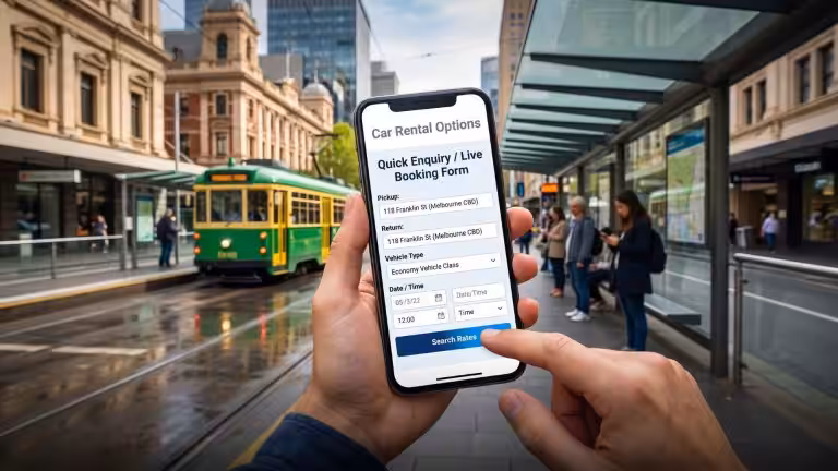 A person uses a smartphone to fill out an economy vehicle booking form while standing at a tram stop. This mobile search serves as an insider method for securing the cheapest car rental in Melbourne.