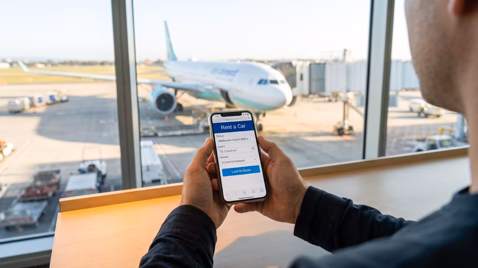 A traveler using an online portal to secure an affordable car rental directly from Melbourne Airport. Booking online is a proven way to lock in lower rates before you land.